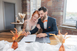 Bride and groom signing wedding register